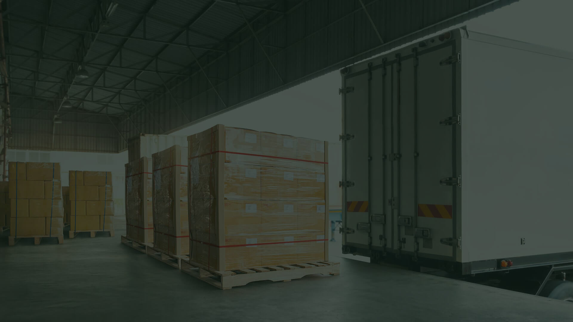 A loading dock with pallets of boxes ready to be loaded into trucks