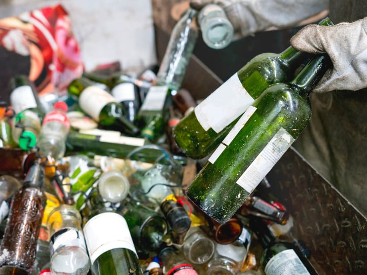 Glass and plastics bottles being sorted manually